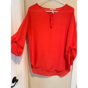 Salmon colored blouse(not red)